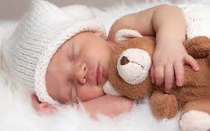 new born with teddy bear