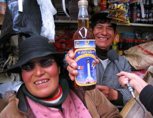 Native Peruvians with bottled Maca drink