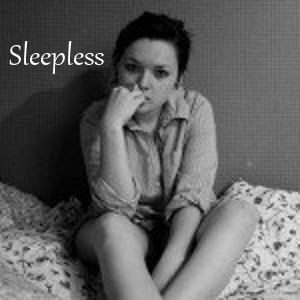 Sleepless - girl with dark circles under her eyes sitting on bed